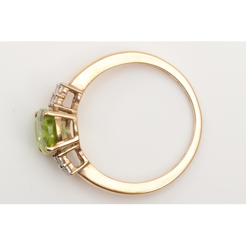 528 - A 9ct gold peridot and white gemstone dress ring, P 1/2