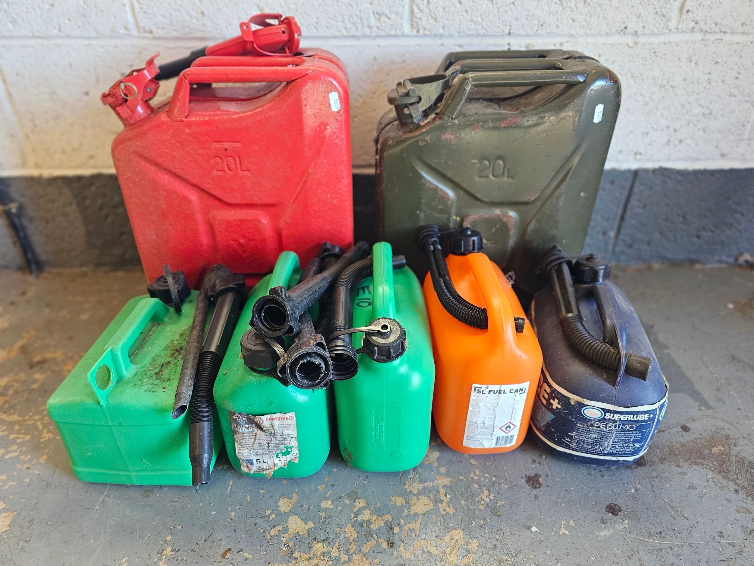 Two 20lt Jerry cans, and five plastic 1 gallon cans and A Singer