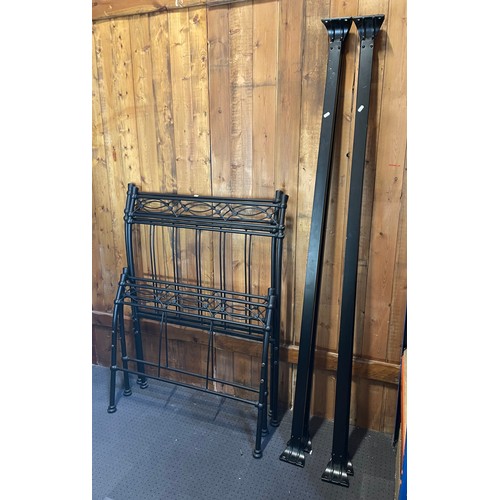 A pair of modern pine single bedsteads, together with a black tubular ...