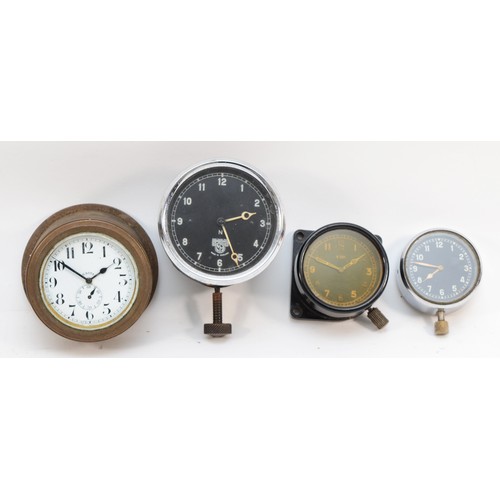 79 - A group of four 20th century dashboard clocks comprising Smiths of London, the black dial with white... 