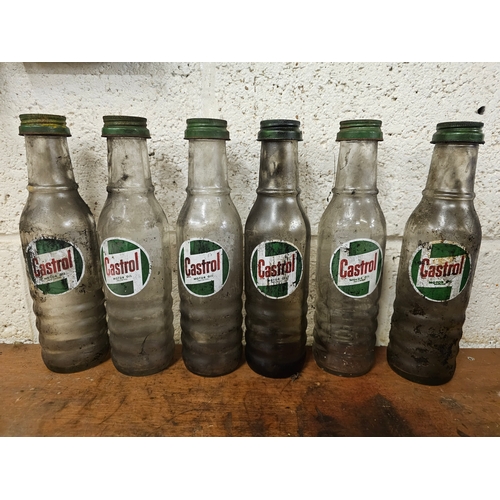 81 - A set of six Castrol glass one pint bottles, all with caps