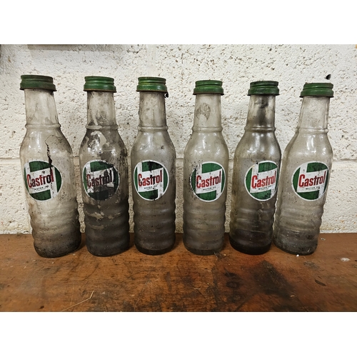 82 - A set of six Castrol glass one pint bottles, all with caps