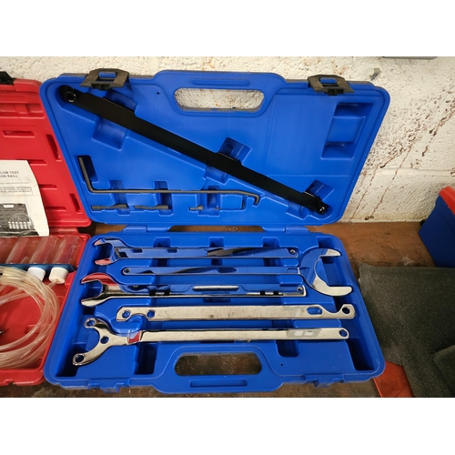 110 - A 15 piece cup oil filter wrench set, a radio removal kit and other tools, mainly unused