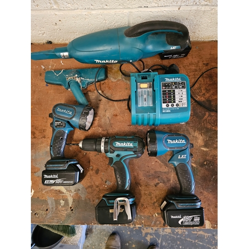 124 - A Makita DC18RA charger, drill BHP452, two torches and a vacuum cleaner