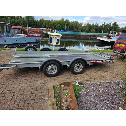 276 - A Brian James, twin axle car trailer, up to 2700KG, with two ramps, manual winch and spare wheel, th... 