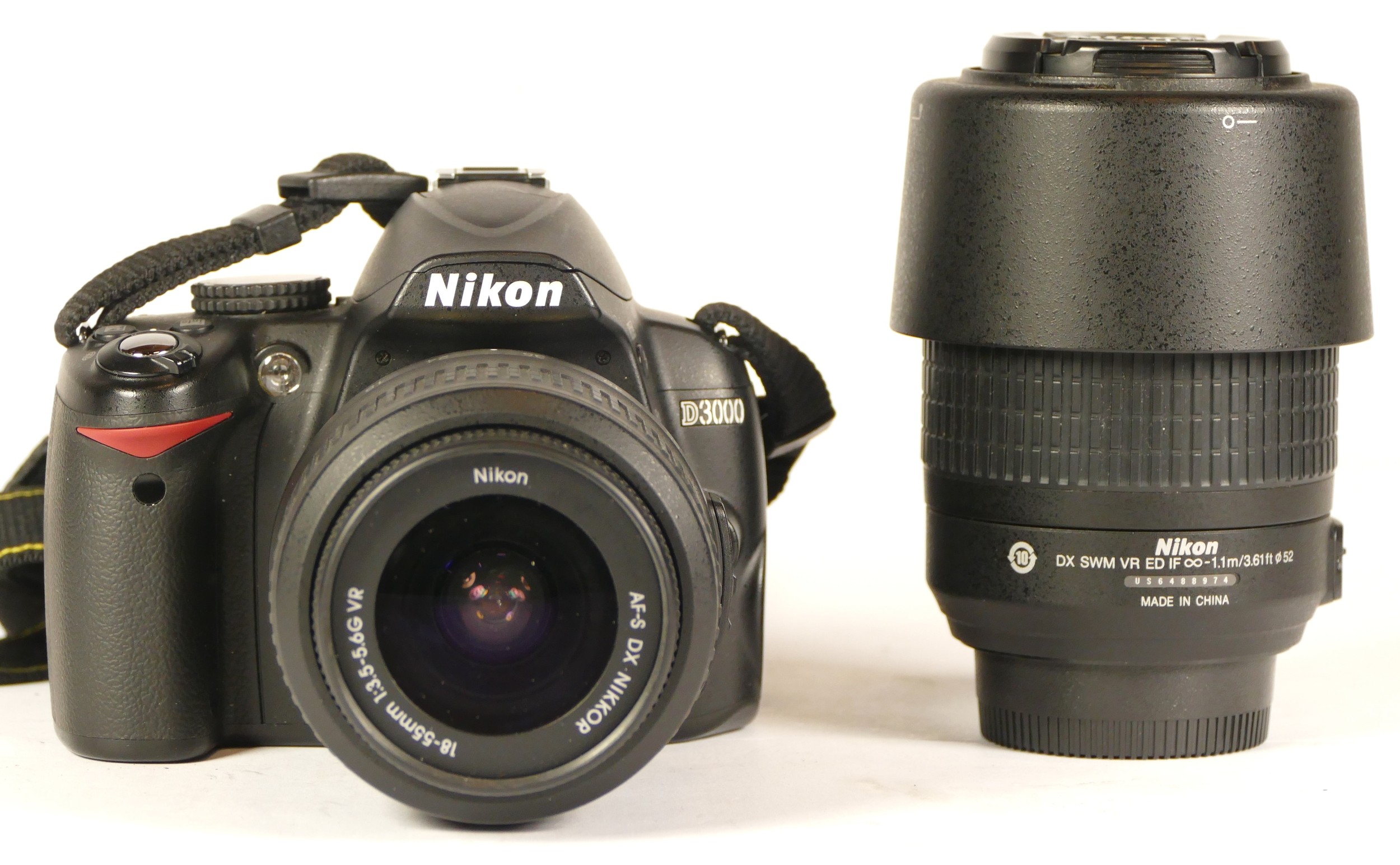 A Nikon D3000 camera with lens (boxed) (working) together with a Nikom