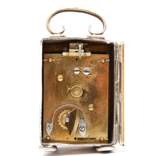 21 - An Edwardian hammered silver miniature carriage clock, by Henry Matthews Birmingham 1921, with swing... 