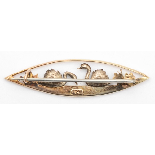 74 - A Victorian 9ct gold navette shaped brooch decorated with two white gold swans, 4 x 1.1 cm, 3gm.