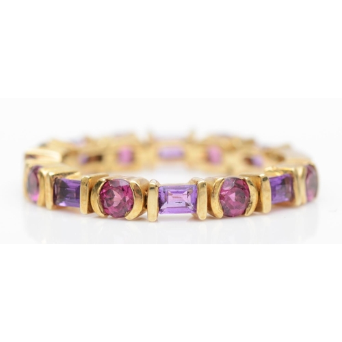 81 - A 9kt gold garnet and amethyst articulated ring, P, 2.8gm.