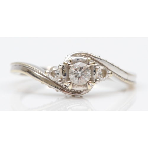 89 - A 9ct white gold brilliant cut diamond dress ring, the middle stone flanked by two smaller diamonds,... 