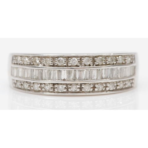 90 - A 9ct white gold diamond half eternity ring, set with channel set baguette cut and eight cut diamond... 