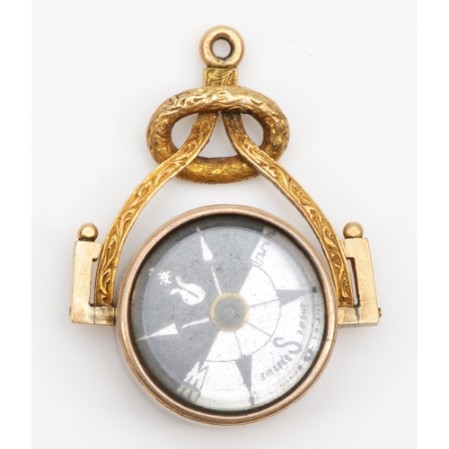 93 - A Victorian unmarked gold swivel watch fob, set with a compass and blood stone, 34 x 25mm, 8.7gm.