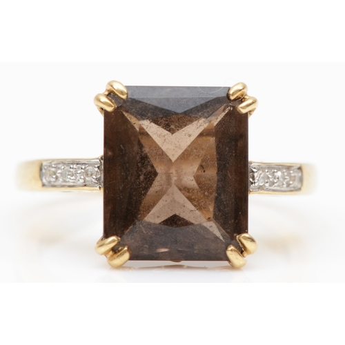 97 - A 9ct gold scissor cut smokey quartz cocktail ring, with diamonds set to the shoulders, K - L, 2.9gm... 