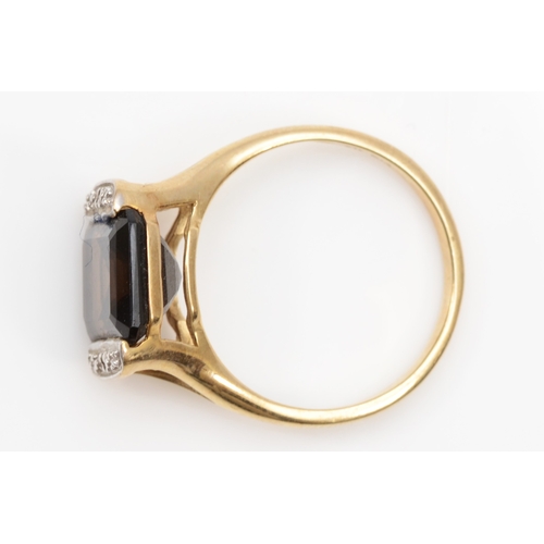 104 - A 9ct gold emerald cut smokey quartz dress ring, the quartz flanked by two illusion set diamonds, P,... 