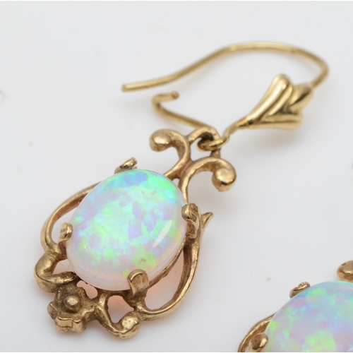 109 - A pair of unmarked gold synthetic opal drop earrings, one with replaced silver post, 17mm, 
 2.2gm.