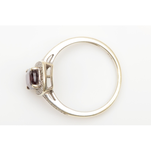 117 - A 9ct white gold almandine garnet and eight cut diamond cluster ring, M, 2.2gm.