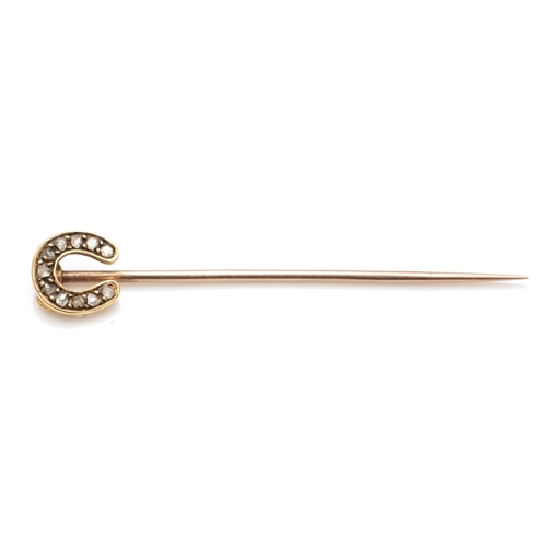 120 - A Victorian unmarked gold horse shoe stick pin, set with mine cut diamonds, 5cm, 1.2gm.