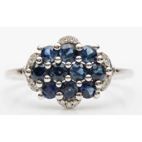 121 - A 9ct white gold sapphire and eight cut diamond cluster ring, Q, 2.6gm.