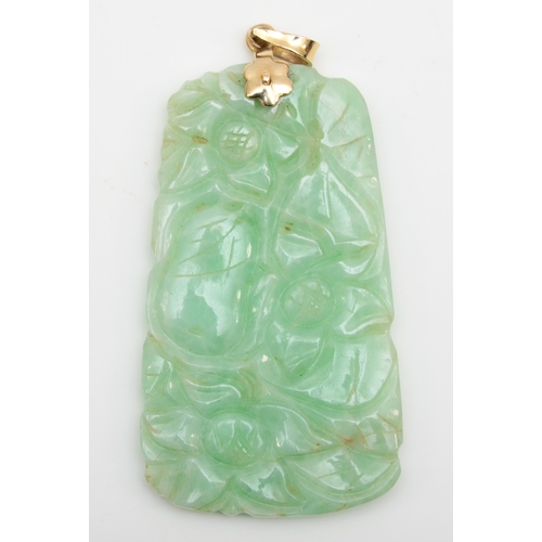 122 - A 14k gold green jadeite floral carved pendant, 46 x 21mm, 11gm.