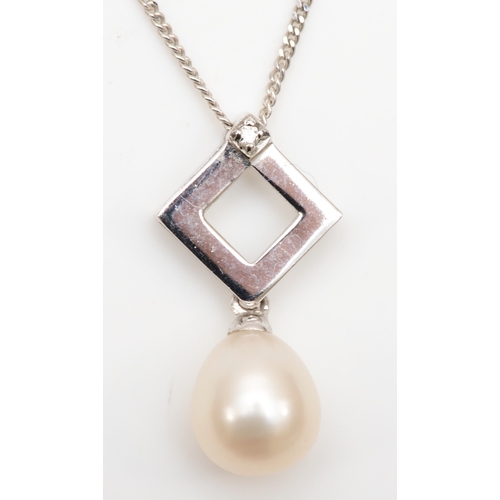 124 - A 9ct white gold cultured pearl and diamond pendant on chain, 19mm, with a matching pair of drop ear... 