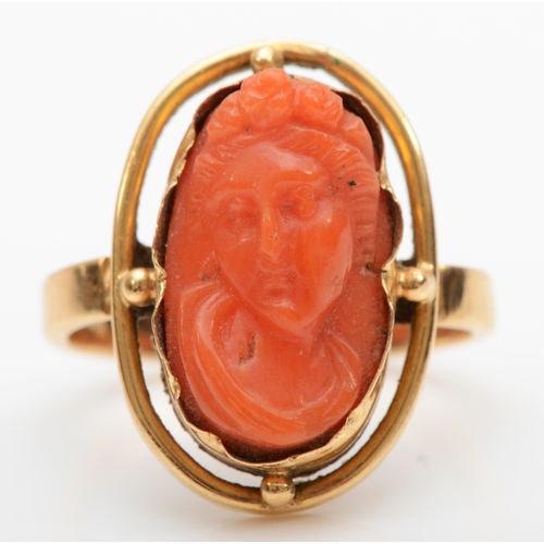 126 - A Victorian carved coral cameo ring depicting a classical maiden, 16 x 10mm, M, 5.2gm.