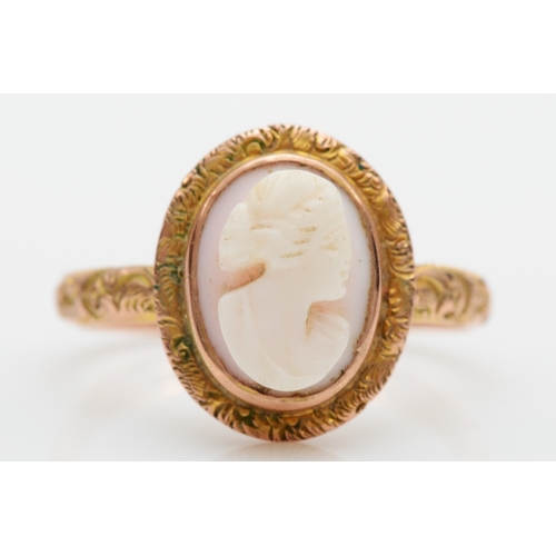 127 - A Victorian unmarked gold conch shell cameo ring, with foliate scroll border and shoulders, S, 5.2gm... 