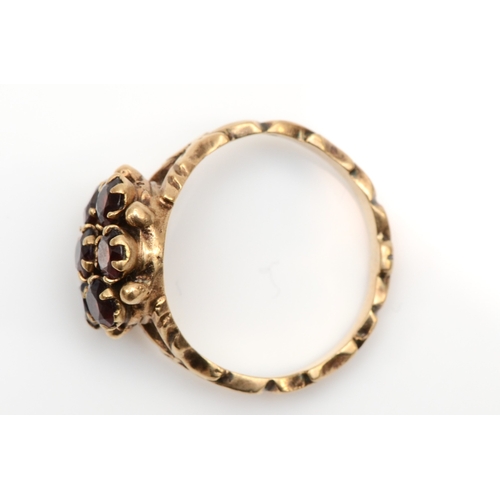 129 - A vintage 9ct gold garnet cluster ring, with textured decorative band, O, 3.8gm.