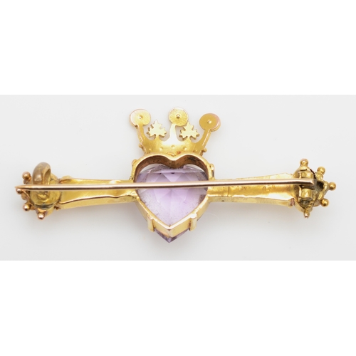 131 - A Victorian 9ct gold heart shaped amethyst bar brooch, the amethyst mounted with a seed pearl set cr... 