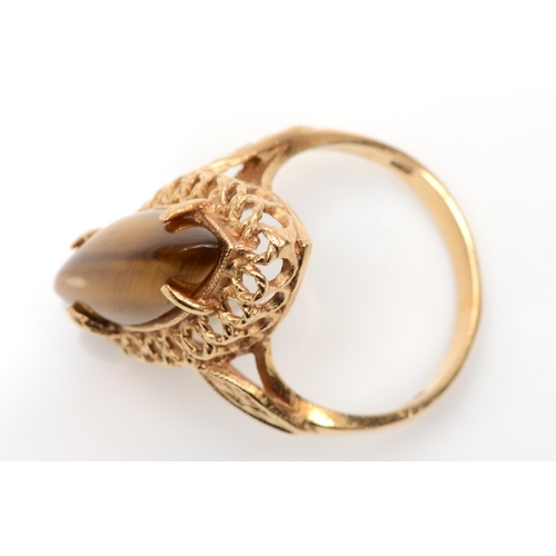 134 - A vintage 9ct gold navette cut tiger's eye cocktail ring, with pierced gallery setting, O, 4.5gm.