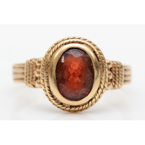 135 - A vintage 9ct gold garnet dress ring, with rope twist and bead decoration, O, 3gm.