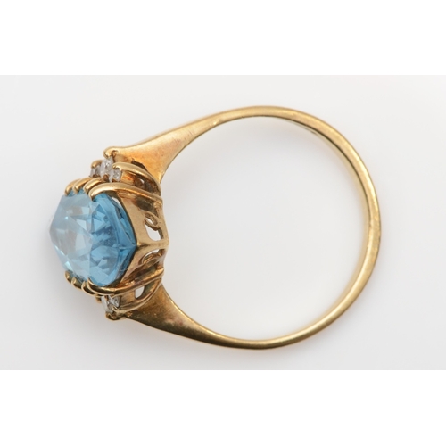 137 - A 9ct gold marquise cut blue topaz and brilliant cut diamond cocktail ring, R, 3.8gm.