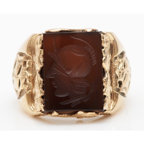 167 - A 9ct gold onyx signet ring, with stylized dolphin and galleon decoration, S-T, 8.3gm.