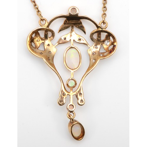 173 - A 10k gold opal and brilliant cut diamond open work pendant, 37mm, on chain 4.9gm.