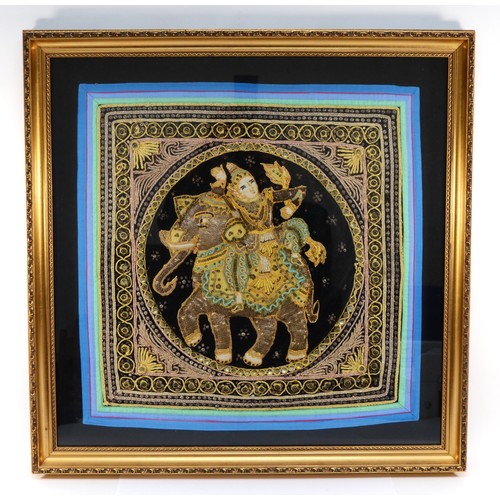 233 - A 20th century Indian stump and beadwork panel, embroidered with a Goddess riding an elephant, frame... 