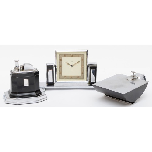 235 - An Art Deco chrome plated desk set compring of a Smiths of London 8 day desk clock, the rotating dia... 