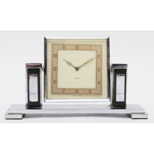 235 - An Art Deco chrome plated desk set compring of a Smiths of London 8 day desk clock, the rotating dia... 