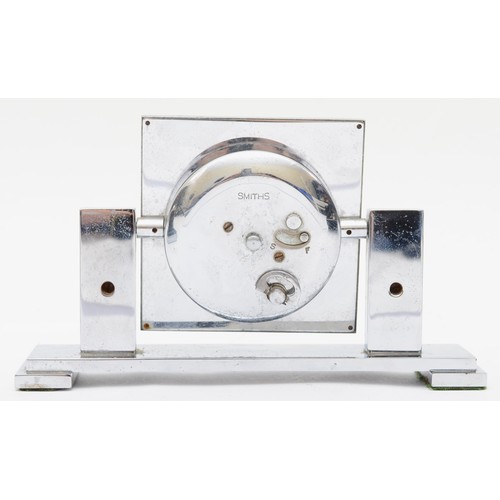 235 - An Art Deco chrome plated desk set compring of a Smiths of London 8 day desk clock, the rotating dia... 