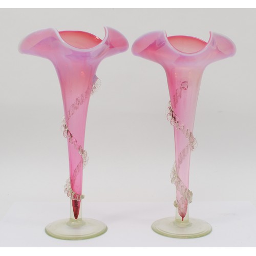 270 - A pair of late 19th/early 20th red vaseline trumpet shaped vases, each with applied clear glass swag... 