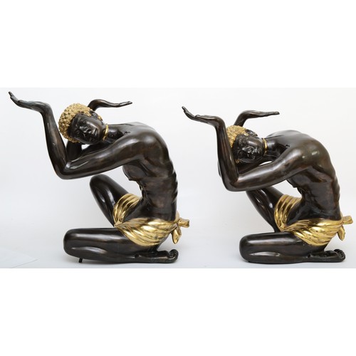 252 - A pair of cast metal blackamoor table supports, cast in the form of kneeling men a with hands up, gi... 