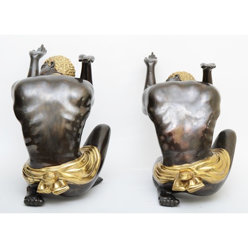 252 - A pair of cast metal blackamoor table supports, cast in the form of kneeling men a with hands up, gi... 