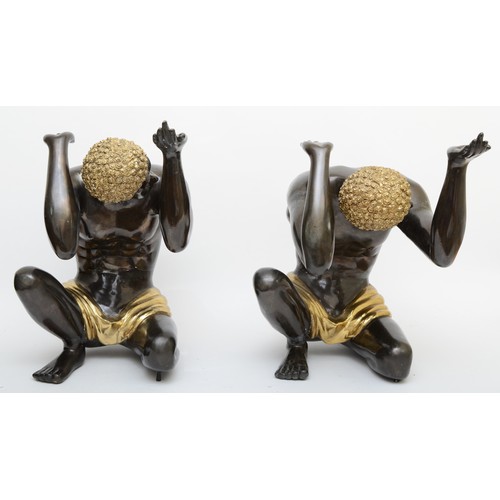 252 - A pair of cast metal blackamoor table supports, cast in the form of kneeling men a with hands up, gi... 