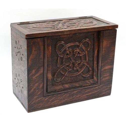 254 - A 19th century carved oak box, with hinged fall front carved with Celtic knot and pokerwork decorati... 