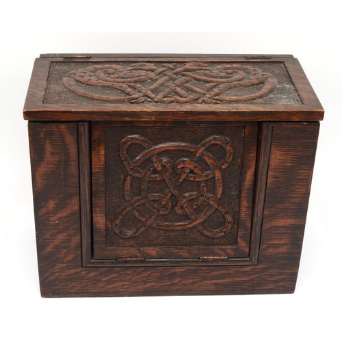 254 - A 19th century carved oak box, with hinged fall front carved with Celtic knot and pokerwork decorati... 