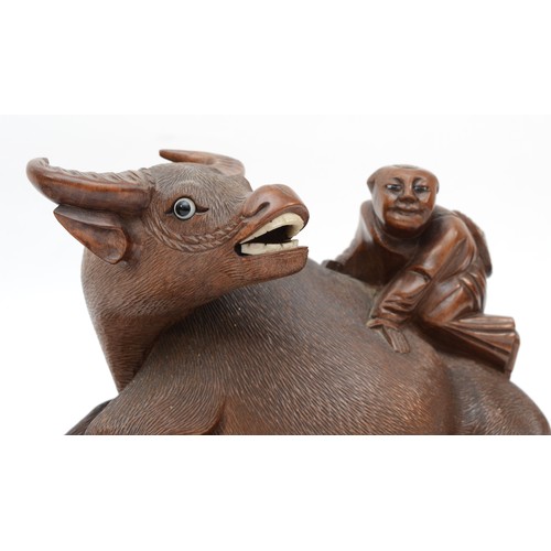 292 - A pair of 20th century Chinese carved hardwood water buffalo with boys riding their back, each with ... 