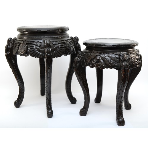 295 - Two 20th century carved Chinese hardwood stands, the tops each incised with Greek Key pattern, with ... 