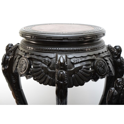 295 - Two 20th century carved Chinese hardwood stands, the tops each incised with Greek Key pattern, with ... 