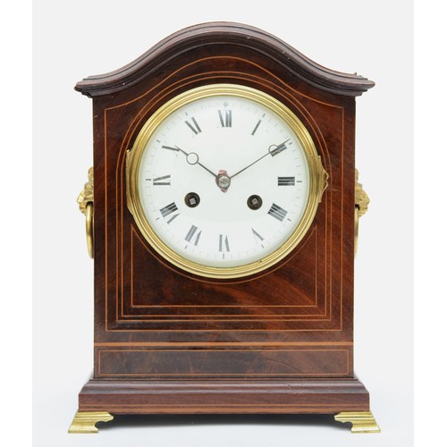 329 - An Edwardian inlaid mahogany mantle arch topped mantle fusee mantle clock, with twin lion mask swing... 