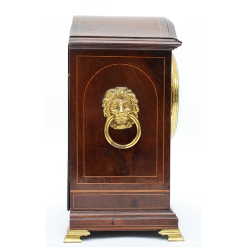 329 - An Edwardian inlaid mahogany mantle arch topped mantle fusee mantle clock, with twin lion mask swing... 