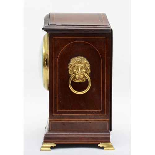 329 - An Edwardian inlaid mahogany mantle arch topped mantle fusee mantle clock, with twin lion mask swing... 