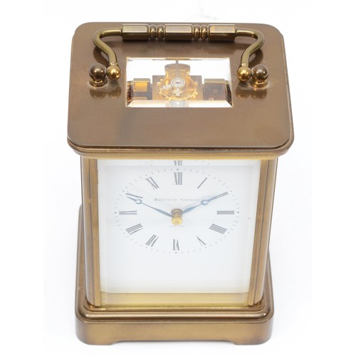 333 - Matthew Norman of London, a 20th century brass corniche and four bevelled glass carriage clock, with... 